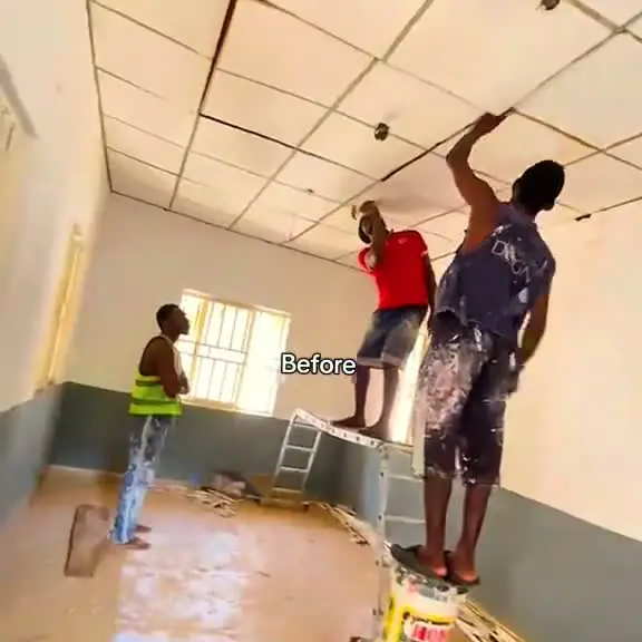 The Tanke office before renovation: a bare room with workers on ladders